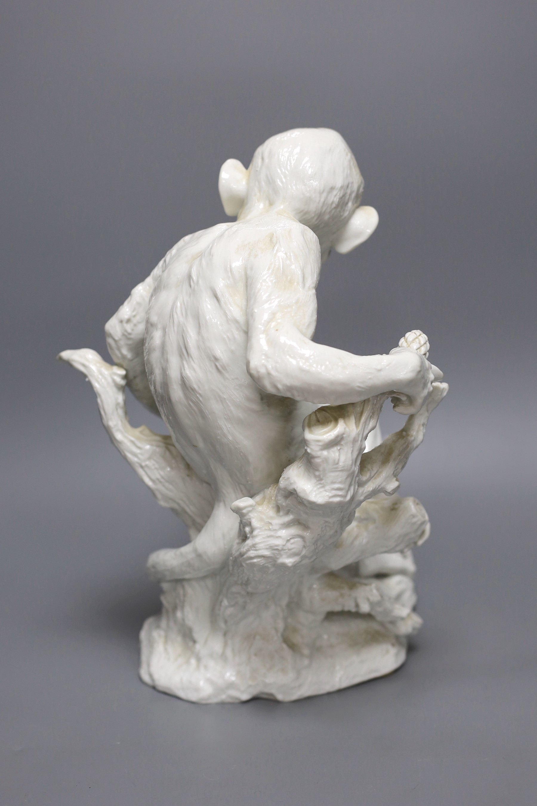 A “Vienna’’ white glazed porcelain model of monkey, seated on a tree bough, 32cm